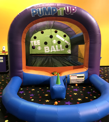 inflatable with wind blowing out for kids to hit a ball and aim through the circles