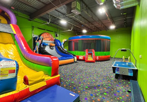 Pump It Up Eden Prairie MN arena filled with inflatable attractions and air hockey table for kids birthday party