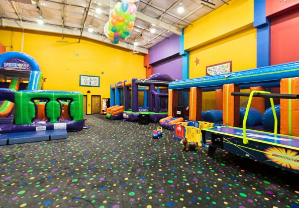 Pump It Up Metro Jackson MS kids birthday party arena filled with inflatable attractions and a balloon drop for private birthday parties