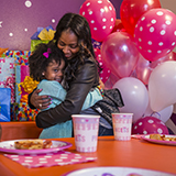 Mom and daughter share a moment at her birthday party