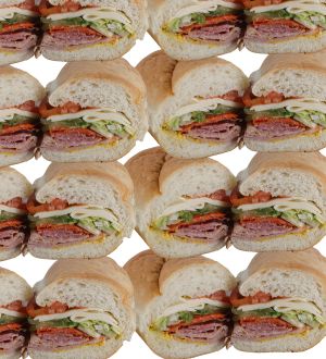 Several sub sandwiches filled with lettuce, tomatoes, cheese and meat.
