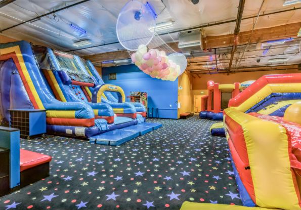 Pump It Up San Jose CA kids birthday party place filled with inflatable attractions and a balloon drop for private birthday parties